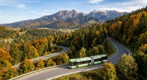 A professional, high-angle editorial photograph of a modern public transport bus winding through the